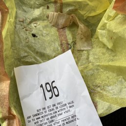 Cheeseburger wrapper with the piece of paper that I found in the burger.