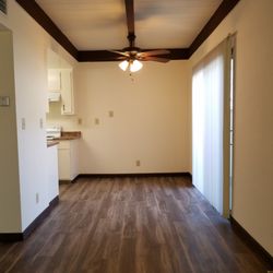 Cadillac Drive Townhomes - 2-Bedroom 1.5 Bath townhome dining area with kitchen on the left and patio coming off the dining area on the right.