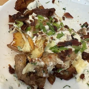 The Sleepy Rooster - Loaded twice crispy potatoes with creamy melted mozzarella cheese, bacon bits with homemade ranch and scallions ( shareable ) - New American Near Me - Chagrin Falls, Ohio The Sleepy Rooster - Loaded twice crispy potatoes with creamy melted mozzarella cheese, bacon bits with homemade ranch and scallions ( shareable ) - New American Near Me - Chagrin Falls, Ohio