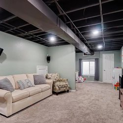 Trinity Custom Home Builders - Finished basement with an eagress window.