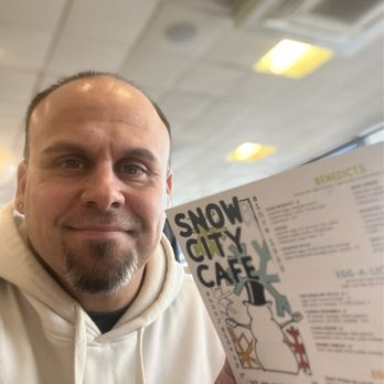 Snow City Cafe - Me holding Snow City Cafe Menu - Breakfast & Brunch Near Me - Anchorage, Alaska Snow City Cafe - Me holding Snow City Cafe Menu - Breakfast & Brunch Near Me - Anchorage, Alaska