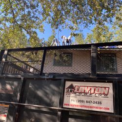 Layton Roofing - A picture of owner and crew working up on my roof with the trailer they used to haul off old shingles in the foreground