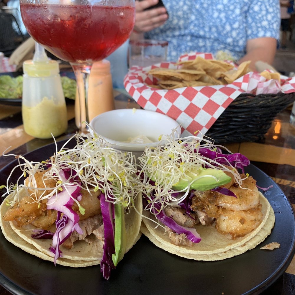 Shrimp and chicken tacos, Janis cocktail, and chips