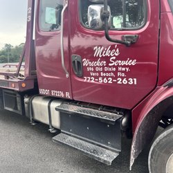 Mike's Garage & Wrecker Service - Tow truck with logo and contact info