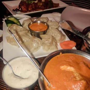 Sathi - top: chilly salmon. middle: steamed chicken momo. bottom left: raita. bottom right: butter chicken - Indian Near Me - New York, New York Sathi - top: chilly salmon. middle: steamed chicken momo. bottom left: raita. bottom right: butter chicken - Indian Near Me - New York, New York