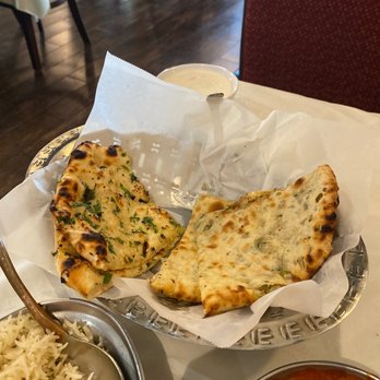 Three Leaf Nepalese Indian Cuisine - Garlic Naan on the left and Onion Kulcha on the right! - Indian Near Me - Houston, Texas Three Leaf Nepalese Indian Cuisine - Garlic Naan on the left and Onion Kulcha on the right! - Indian Near Me - Houston, Texas