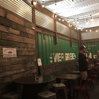 Santa Barbara Cider Company - All the magic happens behind the green shipment containers! - Cideries Near Me - Goleta, California