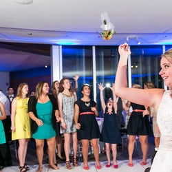 It's Your Night Entertainment - A Bride tossing her bouquet at a wedding reception that It's Your Night, a Dallas Wedding DJ company, was a part of.
