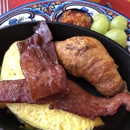 Omelette with spinach, cheese, tomatoes, mushrooms, served with candied maple bacon, croissant and fresh salsa.