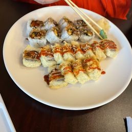 a plate of sushi with chopsticks a plate of sushi with chopsticks