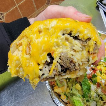 Bajas Tex Mex Grill - a hand holding a burrito - Tex-Mex Near Me - Providence, Rhode Island