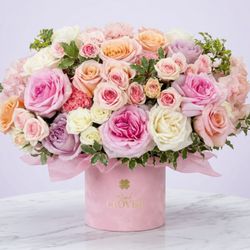 Pink Clover - Peach and lavender roses with pink and yellow-tipped carnations and a hot pink garden rose, framed by ferns.