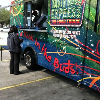Taste Buds Express - a woman ordering food from a food truck - Food Trucks Near Me