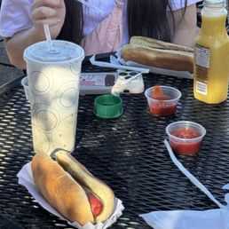 Hot dogs, drink and orange juice. Hot dogs, drink and orange juice.