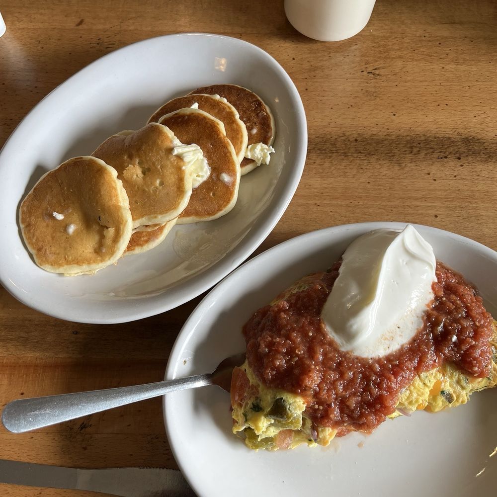 Spanish omelette topped with salsa and sour cream. And six tiny pancakes. Spanish omelette topped with salsa and sour cream. And six tiny pancakes.