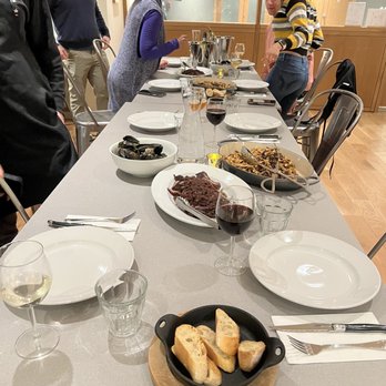 Hudson Table - a long table with plates of food and glasses of wine - Coffee & Tea Near Me - Stamford, Connecticut