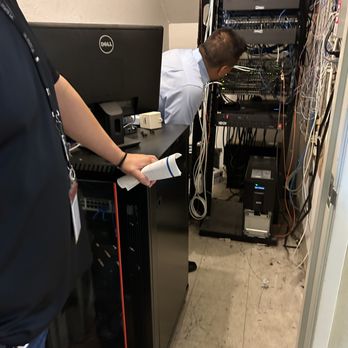 Rigel Technologies Group - Aidan and the client looking at their wiring setup and Network Rack. - IT Services & Computer Repair Near Me Rigel Technologies Group - Aidan and the client looking at their wiring setup and Network Rack. - IT Services & Computer Repair Near Me