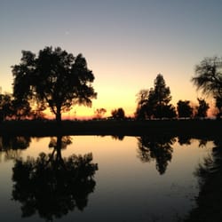 Riverside Golf Course - View of club house at dusk, across the pond.