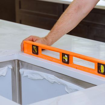 Carpet Exchange - a man using a level on a counter top - Carpeting Near Me - Denver, Colorado Carpet Exchange - a man using a level on a counter top - Carpeting Near Me - Denver, Colorado