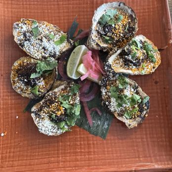 Jekyll & Hyde - flame-grilled oysters w chorizo and cilantro-lime butter, topped w toasted breadcrumbs.  Even if you don't like oysters- you will love - Mexican Near Me - St. Louis, Missouri