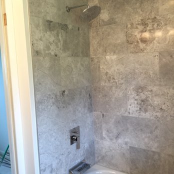 Bathroom Solutions - a bathtub and shower in a bathroom - General Contractors Near Me