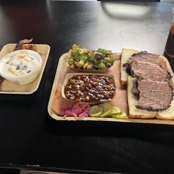 One meat platter with brisket, pork belly sprouts, and baked beans. Also banana pudding and candied bacon on the side. Highly recommend!