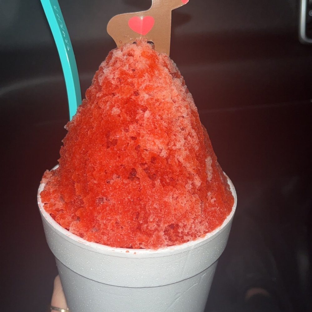 a person holding a cup of ice cream
