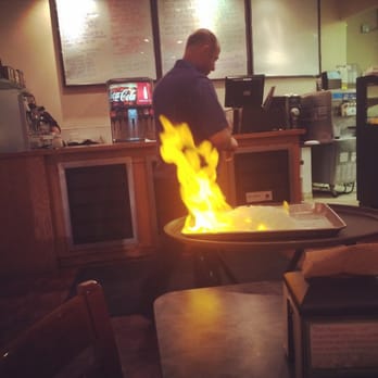 Zizi's Cafe - Zizi lighting our seabass on fire - Mediterranean Near Me - Chicago, Illinois