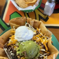 Ground beef taco salad (ground beef, lettuce, tomatoes, cheese, sour cream and guacamole served inside a deep fried tortilla.