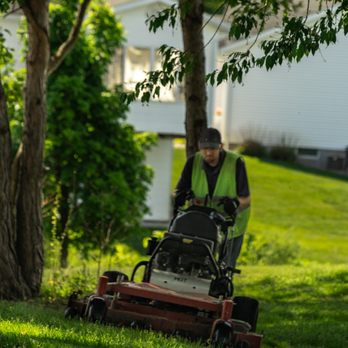 Dykstra Landscape Management - a man mowing the grass - Landscaping Near Me - Grand Haven, Michigan Dykstra Landscape Management - a man mowing the grass - Landscaping Near Me - Grand Haven, Michigan