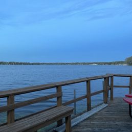 a picnic table on a pier overlooking the water