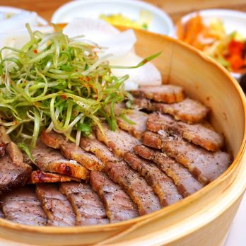 Han Oak - Pork Bo Ssam (보쌈): koji marinated, slow roasted pork belly, pickled daikon sheets, rice paper, scallion salad, with mixed grain rice ($27). - Korean Near Me - Portland, Oregon Han Oak - Pork Bo Ssam (보쌈): koji marinated, slow roasted pork belly, pickled daikon sheets, rice paper, scallion salad, with mixed grain rice ($27). - Korean Near Me - Portland, Oregon