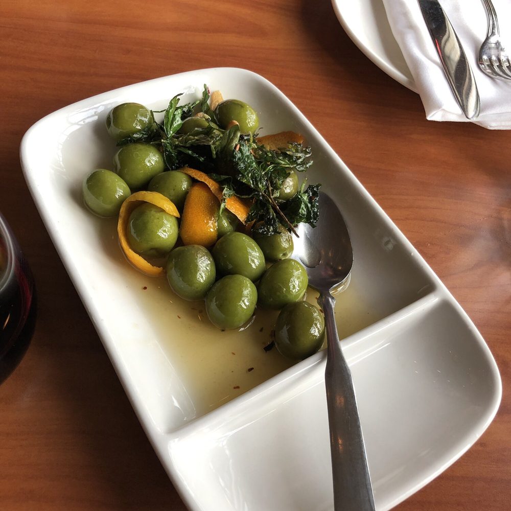 Capers + Olives - Beautiful and delicious warmed castelvetrano olives with orange peel and fried herbs... Delicious! - Italian Near Me - Everett, Washington Capers + Olives - Beautiful and delicious warmed castelvetrano olives with orange peel and fried herbs... Delicious! - Italian Near Me - Everett, Washington