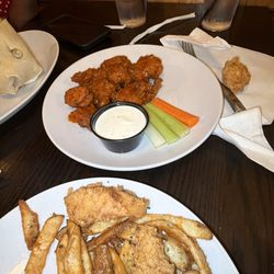 Boneless wings and chicken tenders with fries