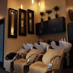 In a Wink Beautique - Reclining massage chairs at the rinse stations.