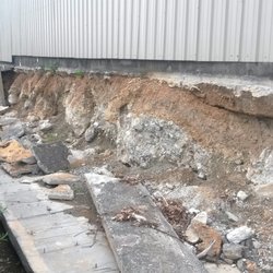 Forward Storage - The rear of the building where the retaining wall has collapsed into the drainage canal. The buildings are next to fall!
