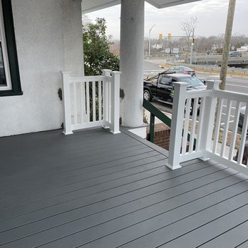 LMB landscaping - a porch with railings and a light fixture - Landscaping Near Me