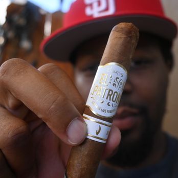 LaGrone Cigar - a man holding a cigar - Cigar Bars Near Me - Reno, Nevada LaGrone Cigar - a man holding a cigar - Cigar Bars Near Me - Reno, Nevada