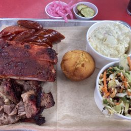 Louisiana Hot Links, Pork Ribs, Juicy Beef Brisket, Potato Salad, Cilantro Peanut Slaw with a Corn Muffin Louisiana Hot Links, Pork Ribs, Juicy Beef Brisket, Potato Salad, Cilantro Peanut Slaw with a Corn Muffin