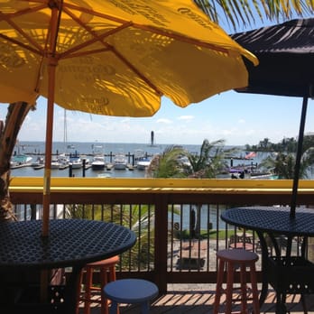 Row Boat Willies - tables and umbrellas on a deck - Bars Near Me - Edgemere, Maryland
