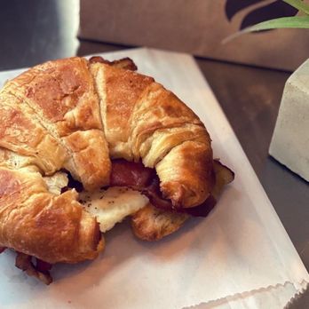 Ellianos Coffee - a croissant sandwich on a napkin - Coffee & Tea Near Me - Lake City, Florida Ellianos Coffee - a croissant sandwich on a napkin - Coffee & Tea Near Me - Lake City, Florida