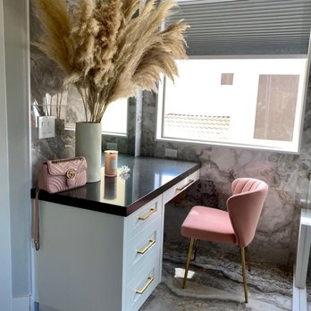 Wendler Construction - a desk with a chair and a vase of flowers - General Contractors Near Me