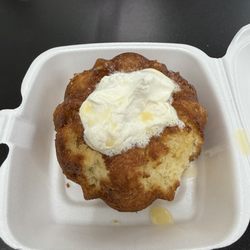 One Love Island Cuisine - Whipped cream on top of a Bundt cake (served this way) no ice cream although advertised that it comes with ice cream