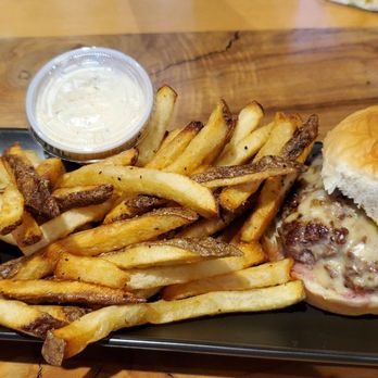 The Wilds Taphouse & BBQ - Old school  burger, 1/4lb  smash burger with grilled onions and mustard - Barbeque Near Me - Newport, Oregon
