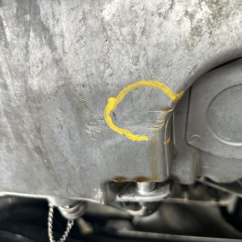 AAA - Showing crack of oil pan after being dropped on "Stinger" by AAA Driver - Auto Repair Near Me - Henderson, Nevada