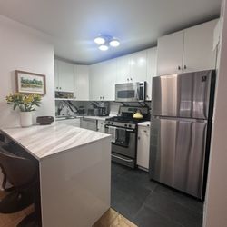 Manhattan Cabinets - New floor, refaced cabinets and countertop.