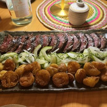 COTOA - El Pincho - perfectly seasoned and cooked Hanger steak with the lightest, crispiest potatoes and cucumber/onion salad to cut the richness. - Latin American Near Me - Miami, Florida COTOA - El Pincho - perfectly seasoned and cooked Hanger steak with the lightest, crispiest potatoes and cucumber/onion salad to cut the richness. - Latin American Near Me - Miami, Florida