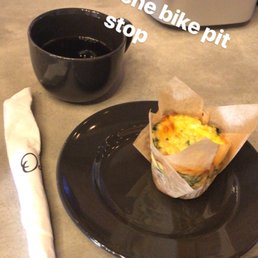 a plate with a muffin and a cup of coffee