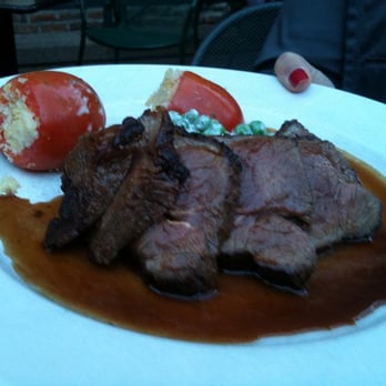 Bistro Vendôme - Pan seared lamb sirloin, chèvre-stuffed Roma tomatoes, English pea and crème fraîche salad, red wine sauce. - French Near Me - Denver, Colorado Bistro Vendôme - Pan seared lamb sirloin, chèvre-stuffed Roma tomatoes, English pea and crème fraîche salad, red wine sauce. - French Near Me - Denver, Colorado