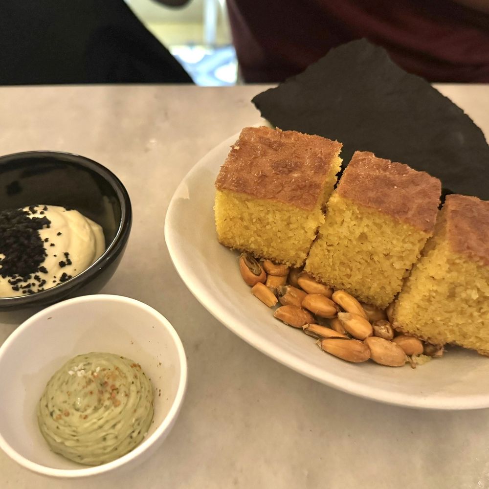 A Cevicheria - Corn Nut, Cuttlefish Ink Flatbread, Cornbread, Basal Butter and Aji Amarillo Sauce - Gastropubs Near Me - Lisbon, 11 A Cevicheria - Corn Nut, Cuttlefish Ink Flatbread, Cornbread, Basal Butter and Aji Amarillo Sauce - Gastropubs Near Me - Lisbon, 11